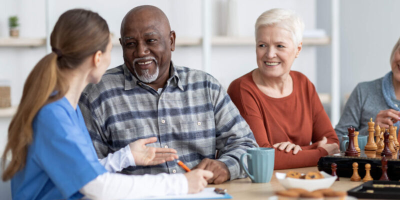 What to Look for and Questions to Ask When Touring Senior Living Communities Group at table having conversation