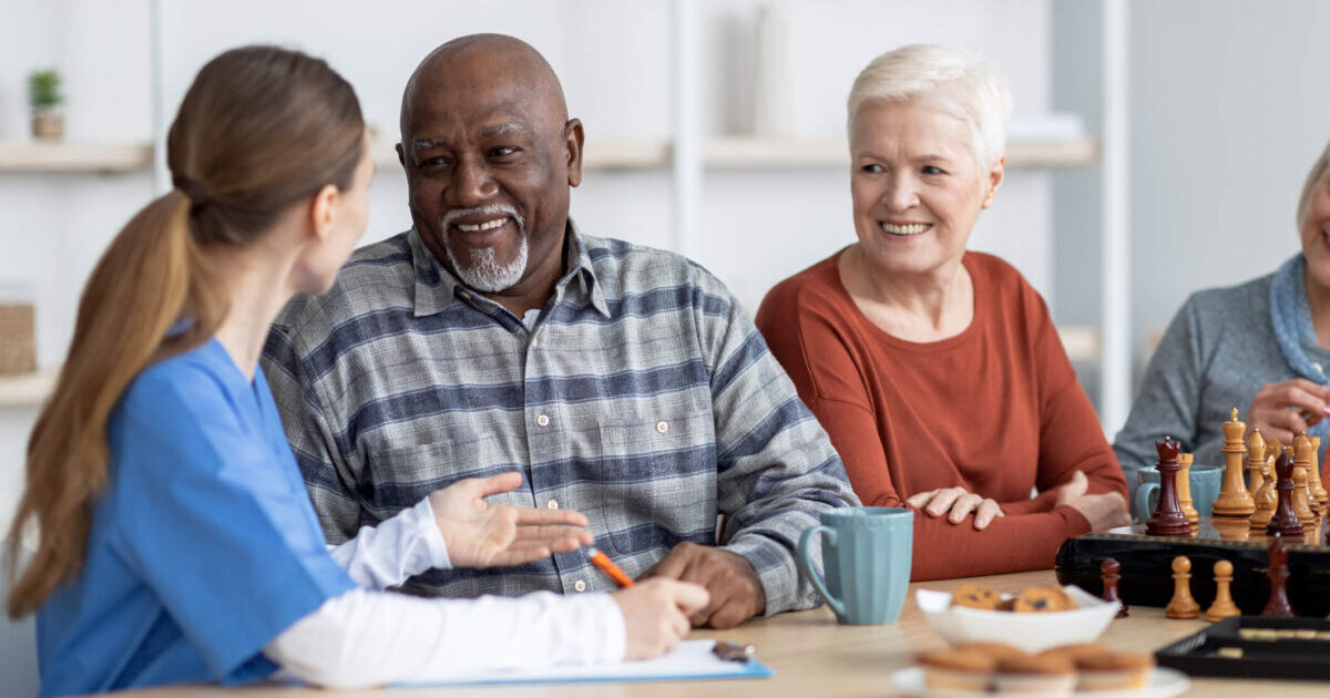 What to Look for and Questions to Ask When Touring Senior Living Communities Group at table having conversation